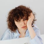 curly haired woman having a financial problem