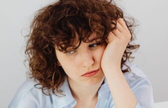 curly haired woman having a financial problem