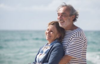 elderly couple hugging