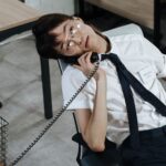 man wearing eyeglasses on a phone call